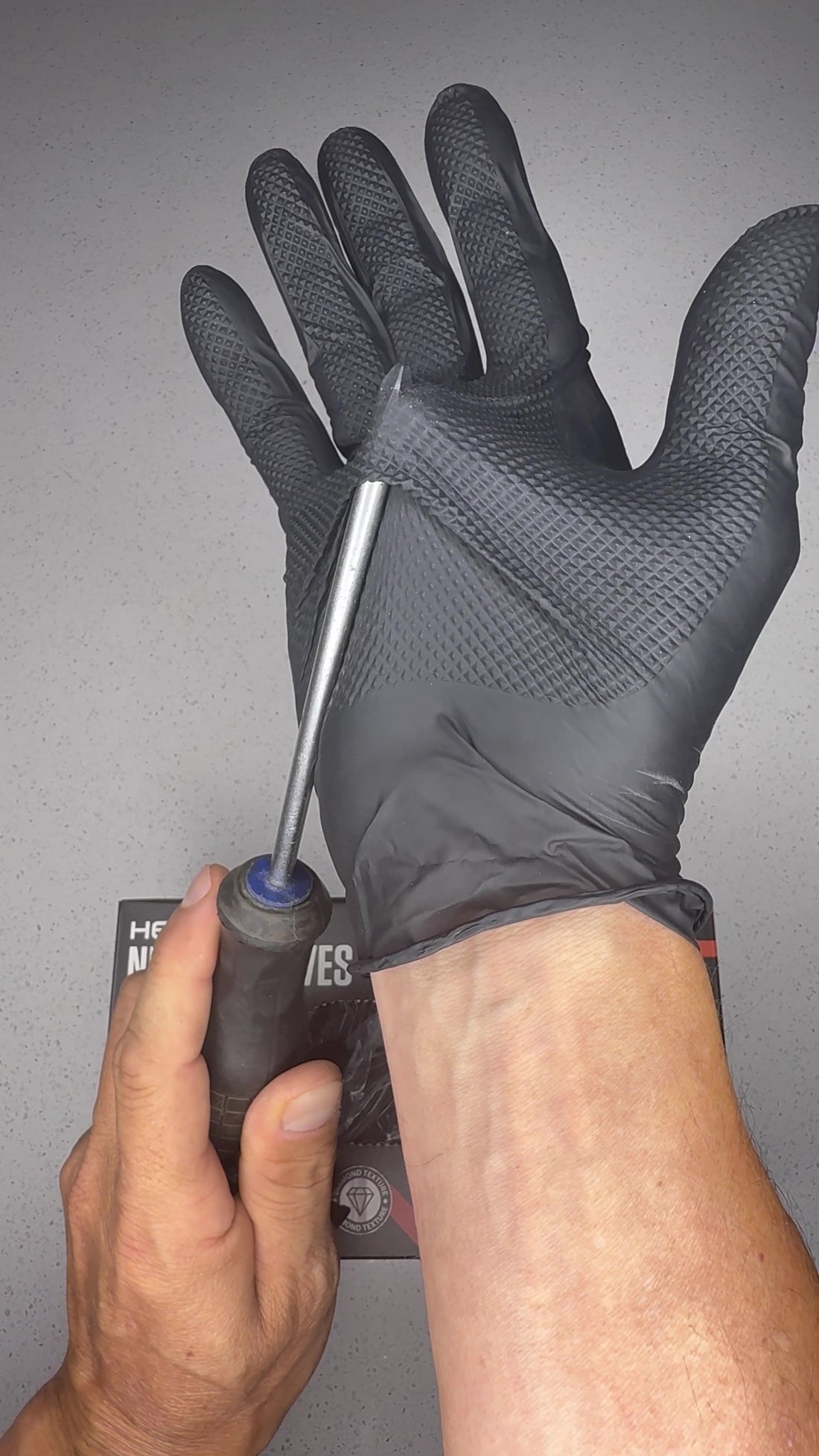Close view of the diamond textured grip on the OGE 4X4 7 mil nitrile glove during our own bench demonstration.